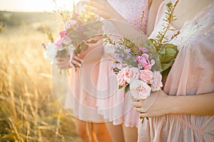 Bridesmaids in pink dresses with bouquets