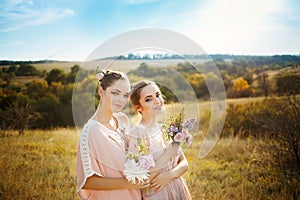 Bridesmaids in pink dresses with bouquets