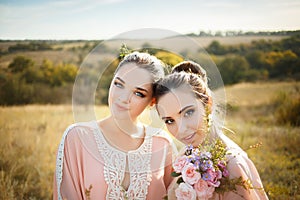 Bridesmaids in pink dresses with bouquets