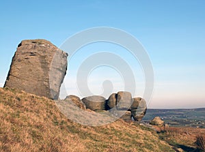 The bridestones a large group of gritstone rock formations in west yorkshire landscape near todmorden against pennine countryside photo