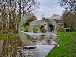 Bridge 108 and the lower gates of Wharton`s Lock on the Shropshire Union Canal near Beeston in Cheshire, England