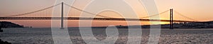 Bridge 25 de Abril on river Tagus at sunset, Lisbon photo