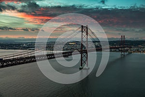 Bridge of 25th April with cars after sunset