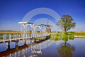bridge across a canal and traditional windmill, Kinderdijk, Holland