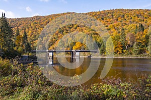 A Bridge Across the Jacques-Cartier River Surrounded by Fall Colors