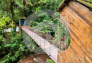 Bridge across Rio Tigre waterfall in jungle of Oxapampa in Peru photo