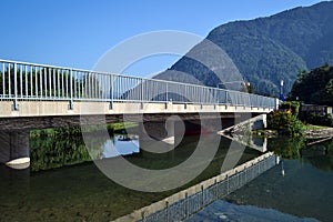 Bridge across the river, reflected in water