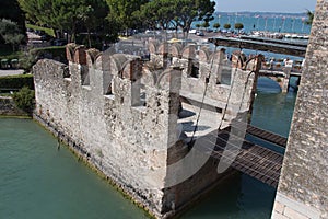 Bridge across water moat at the Scaliger Castle entrance to old town, Sirmione, Lombardy, Italy