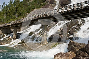 Bridge across a waterfall photo