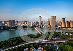 Bridge across the Yongjiang River and buildings along the river bank in Nanning, Guangxi, China