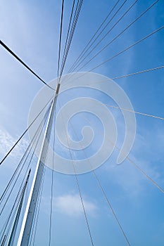 Bridge architecture, pylon and steel cables structure, clear blue sky background
