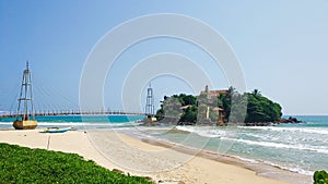 Bridge from the beach to the island in the ocean