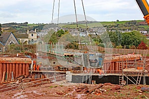 Bridge beam being lowered by a crane