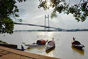 Boats and Bridge beautify the evening sunset at princep ghat,  Kolkata