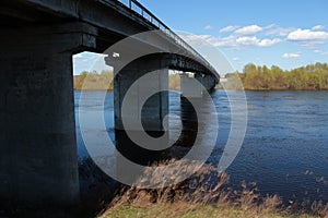 Bridge. Bridge over river. Old gray bridge across the river. Spring.