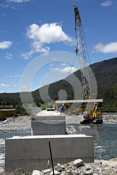 Bridge builders swing in another beam