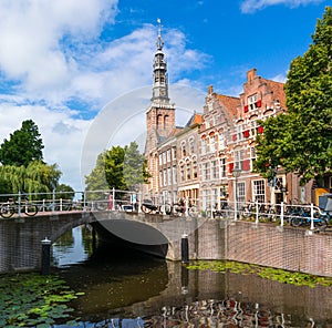 Bridge, church tower and houses Steenschuur canal in Leiden, Net