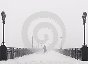 Bridge city landscape in foggy snowy winter day