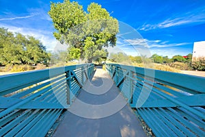 Bridge with concrete pathway and metal railings at Sweetwater Wetlands in Tucson, Arizona