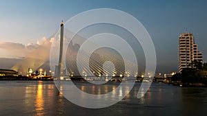 The bridge construction on twilight and river reflection at night