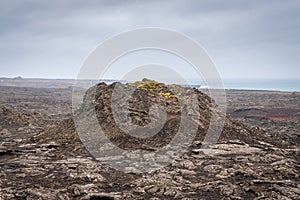 Bridge between continents in Iceland volcanic rock pushing upwards breaking apart small volcano