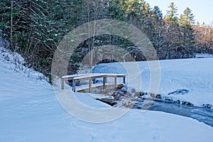 A bridge crossing over a frozen creek