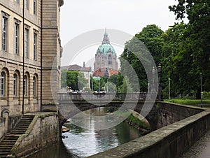 a bridge crossing over a river in a city area with tall buildings