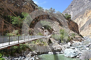 Bridge crossing the river on bottom of Colca Canyon
