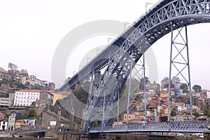 A bridge crossing the river in Porto and colorful houses
