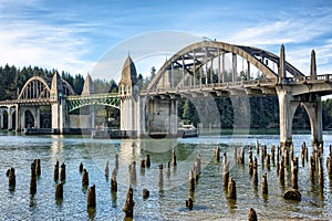 Bridge crossings and river with tree stumps, Florence OR.