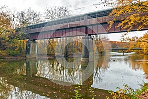 The Bridge of Dreams is a covered Bridge spanning over Mohican river in a fall season