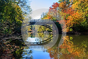 Bridge and fall foliage reflected in the Mill River