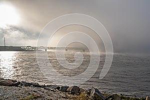 A bridge in fog. Blue ocean and mist in the background. Picture from the bridge connecting Sweden with Denmark