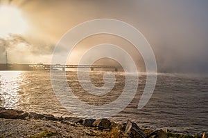 A bridge in fog. Blue ocean and mist in the background. Picture from the bridge connecting Sweden with Denmark