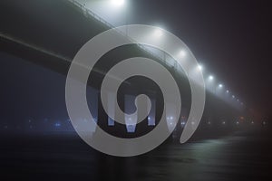 Bridge in the fog or mist by night