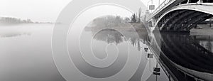 Bridge in the fog. River landscape. Street lights.