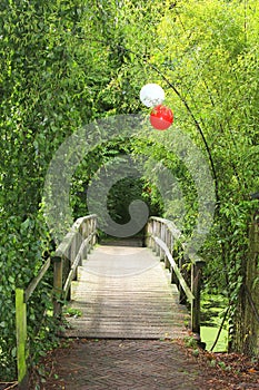 Bridge in the forest decorated with balloons for celebrations, weddings and Mothers Day