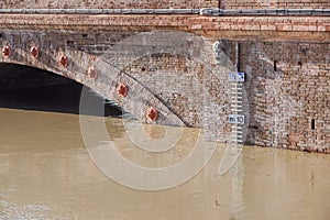 Bridge with full river . River is full . Bridge to cross the river that is flooding.