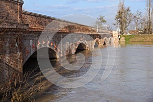 Bridge with full river . River is full . Bridge to cross the river that is flooding.