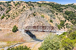 Bridge going over Coyote Creek in South San Francisco Bay Area, California; low water level visible due to existent drought
