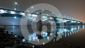 Bridge illuminated at night in the fog