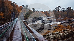 Bridge in the Jay Cooke State Park surrounded by an autumnal foggy forest