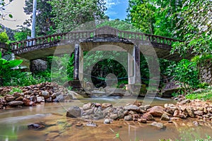 Bridge at Kathu waterfall water gently flowing down the rocks Patong Phuket Thailand Asia