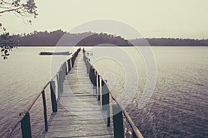 A bridge on the lake surface with mountains