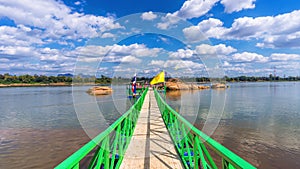 A bridge leading to the Buddha`s Footprint in the middle of the Mekong River in  Nakhon Phanom Province, Thailand