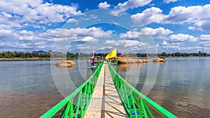 A bridge leading to the Buddha`s Footprint in the middle of the Mekong River in  Nakhon Phanom Province, Thailand