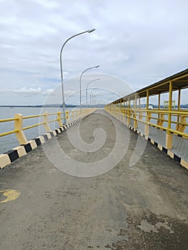 the bridge leading to the ferry port when the weather is cloudy on sebatik island
