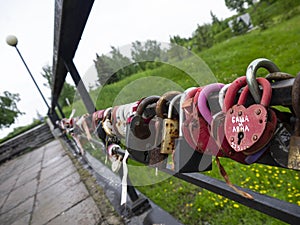 Bridge of love with multi-colored padlocks of the newlyweds.