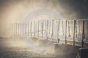 Bridge made of concrete blocks over the river in winter