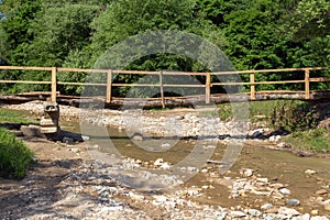 A bridge made of wooden bars and planks, a structure for crossing the river during floods and raising the water level in the rainy